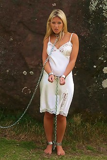 Cute model Belle chained to giant stone